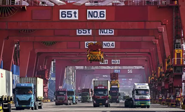 FILE - In this photo released by Xinhua News Agency, containers are unloaded from a cargo ship at Qingdao Port, east China's Shandong Province on Feb.11, 2024. (Li Ziheng/Xinhua via AP, File)