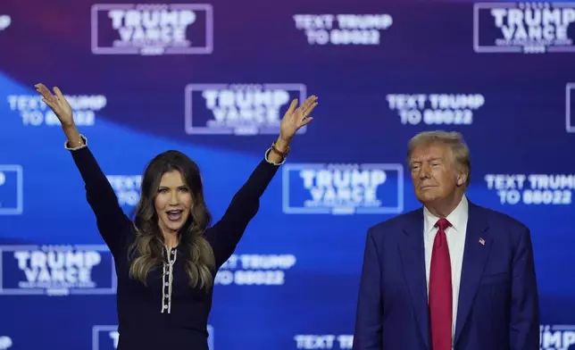 FILE - Republican presidential nominee former President Donald Trump and South Dakota Gov. Kristi Noem dance to the song "Y.M.C.A." at a campaign town hall at the Greater Philadelphia Expo Center &amp; Fairgrounds, Oct. 14, 2024, in Oaks, Pa. (AP Photo/Matt Rourke, File)