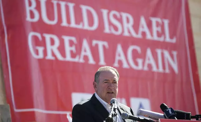 FILE - Gov. Mike Huckabee, R-Ark., takes questions from the media, prior to laying a brick at a new housing complex in the West Bank settlement of Efrat, Aug. 1, 2018. President-elect Donald Trump will nominate former Arkansas Gov. Mike Huckabee as ambassador to Israel. Trump said Tuesday that Huckabee is a staunch defender of Israel and his intended nomination comes as Trump has promised to align U.S. foreign policy more closely with Israel’s interests as it wages wars against Hamas in Gaza and Hezbollah in Lebanon.(AP Photo/Oded Balilty, File)