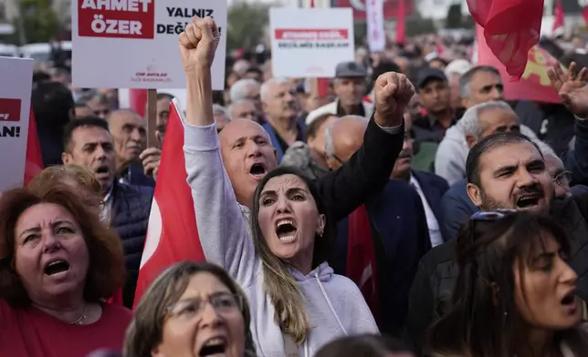 People chant slogans during a protest against the arrest and removal from office of a mayor from Turkey's main opposition party for alleged links to a banned Kurdish militant group, in Istanbul, Turkey, Thursday, Oct. 31, 2024. (AP Photo/Khalil Hamra)