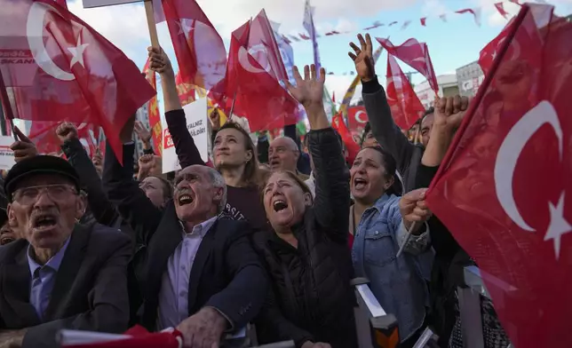 People chant slogans during a protest against the arrest and removal from office of a mayor from Turkey's main opposition party for alleged links to a banned Kurdish militant group, in Istanbul, Turkey, Thursday, Oct. 31, 2024. (AP Photo/Khalil Hamra)