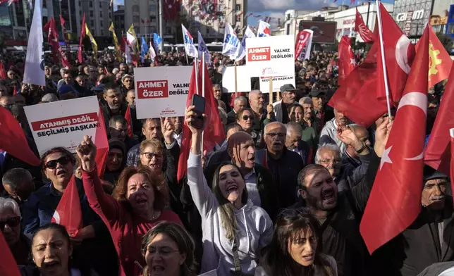 People chant slogans during a protest against the arrest and removal from office of a mayor from Turkey's main opposition party for alleged links to a banned Kurdish militant group, in Istanbul, Turkey, Thursday, Oct. 31, 2024. (AP Photo/Khalil Hamra)