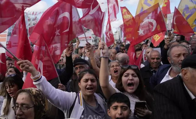 People chant slogans during a protest against the arrest and removal from office of a mayor from Turkey's main opposition party for alleged links to a banned Kurdish militant group, in Istanbul, Turkey, Thursday, Oct. 31, 2024. (AP Photo/Khalil Hamra)