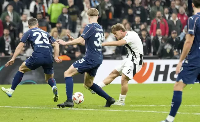 Besiktas' Semih Kilicsoy scores his side's second goal during the Europa League opening phase soccer match between Besiktas and Malmo at the Besiktas stadium in Istanbul, Turkey, Wednesday, Nov. 6, 2024. (AP Photo/Khalil Hamra)