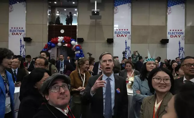 U.S. Ambassador to China Nicholas Burns watches with other attendees as voting results are displayed on screen at a reception for the U.S. presidential election held at the U.S. Embassy in Beijing, Wednesday, Nov. 6, 2024. (AP Photo/Ng Han Guan)