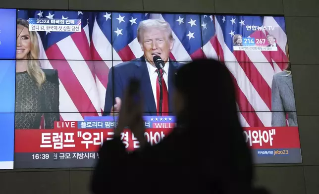 A screens shows live footage of Republican presidential nominee former President Donald Trump speech during a news program in Seoul, South Korea, Wednesday, Nov. 6, 2024. (AP Photo/Lee Jin-man)