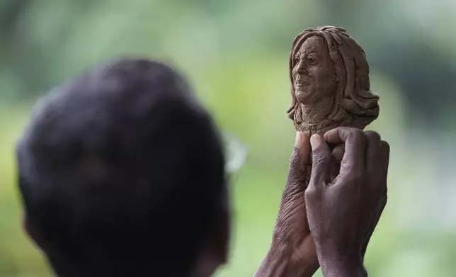 Artist Upali Dias holds a sculpture of US Vice President Kamala Harris in Colombo, Sri Lanka, Tuesday, Nov. 5, 2024. (AP Photo/Eranga Jayawardena)