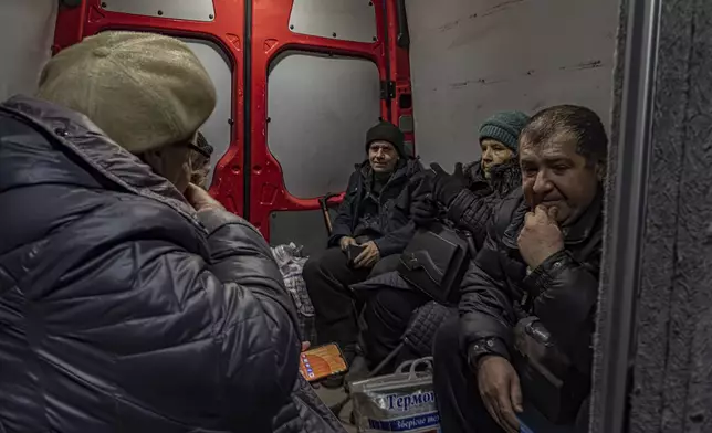 Locals ride inside a van during en evacuation from Kurakhove, Donetsk region, Ukraine, on Nov. 7, 2024. (AP Photo/Anton Shtuka)