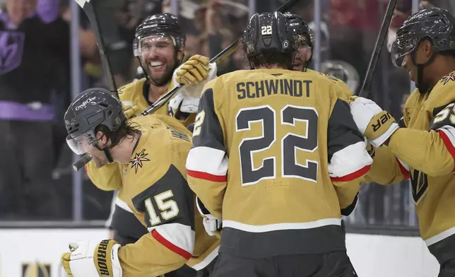 Vegas Golden Knights defenseman Noah Hanifin (15) celebrates with teammates after scoring a goal during the second period of an NHL hockey game against the Utah Hockey Club, Saturday, Nov. 2, 2024, in Las Vegas. (AP Photo/Ian Maule)