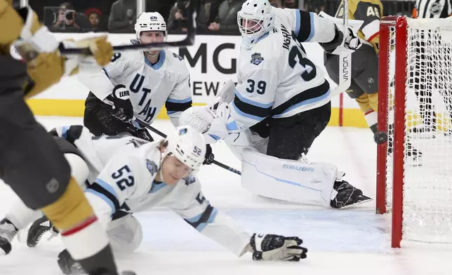 Utah Hockey Club defensemen Vladislav Kolyachonok (52), Ian Cole (28), and goaltender Connor Ingram (39) fail to prevent a goal during the second period of an NHL hockey game against the Vegas Golden Knights, Saturday, Nov. 2, 2024, in Las Vegas. (AP Photo/Ian Maule)