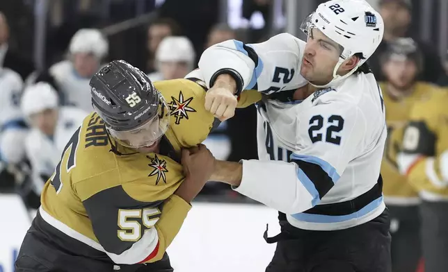 Vegas Golden Knights right wing Keegan Kolesar (55) and Utah Hockey Club center Jack McBain (22) fight during the first period of an NHL hockey game Saturday, Nov. 2, 2024, in Las Vegas. (AP Photo/Ian Maule)