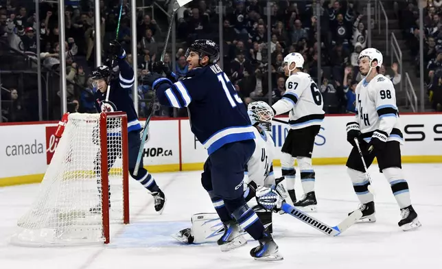 Winnipeg Jets' Gabriel Vilardi (13) scores on Utah Hockey Club goaltender Karel Vejmelka (70) during the second period of an NHL hockey game in Winnipeg, Manitoba, Tuesday Nov. 5, 2024. (Fred Greenslade/The Canadian Press via AP)