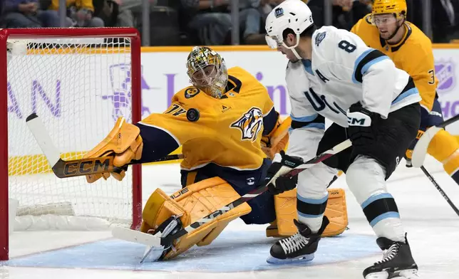 Nashville Predators goaltender Juuse Saros (74) blocks a shot by Utah Hockey Club center Nick Schmaltz (8) during the first period of an NHL hockey game Saturday, Nov. 9, 2024, in Nashville, Tenn. (AP Photo/Mark Humphrey)