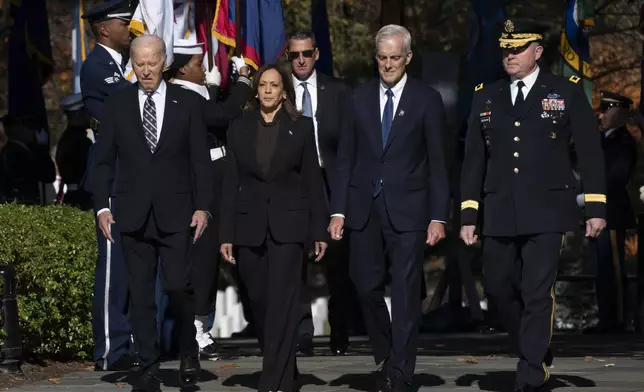 President Joe Biden, from left, Vice President Kamala Harris, Veterans Affairs Secretary Denis McDonough and Maj. Gen. Trevor Bredenkamp, commanding general of the Joint Task Force-National Capital Region and the U.S. Military District of Washington, arrive for a wreath laying ceremony at the Tomb of the Unknown Soldier on National Veterans Day Observance at Arlington National Cemetery in Arlington, Va., Monday, Nov. 11, 2024. (AP Photo/Manuel Balce Ceneta)