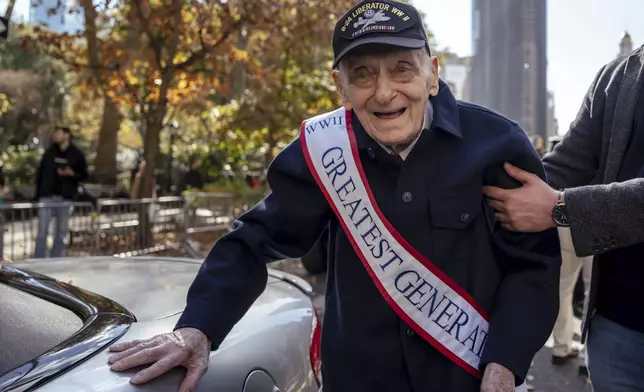 World War II Army Air Corps veteran Walter Rybarczik, 103, is helped to a car before the annual Veterans Day Parade, Monday, Nov. 11, 2024, in New York. (AP Photo/Adam Gray)