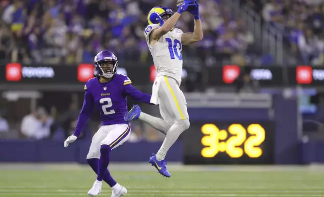 Los Angeles Rams wide receiver Cooper Kupp (10) catches a pass near Minnesota Vikings cornerback Stephon Gilmore (2) during the second half of an NFL football game, Thursday, Oct. 24, 2024, in Inglewood, Calif. (AP Photo/Ryan Sun)