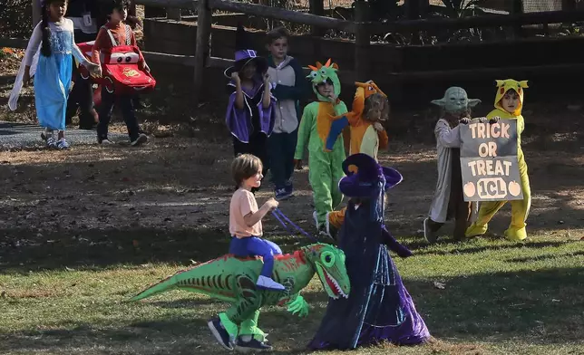 Children at Daniel Warren Elementary School walk in a Halloween parade, Thursday, Oct. 31, 2024, in Mamaroneck, N.Y. (AP Photo/Julie Jacobson)