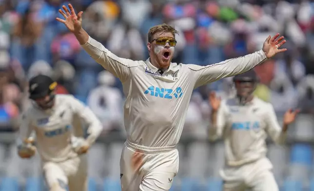 New Zealand's Glenn Phillips celebrates the dismissal of India's Ravichandran Ashwin during the third day of the third cricket test match between India and New Zealand at Wankhede Stadium, in Mumbai, India, Sunday, Nov. 3, 2024.(AP Photo/Rajanish Kakade)