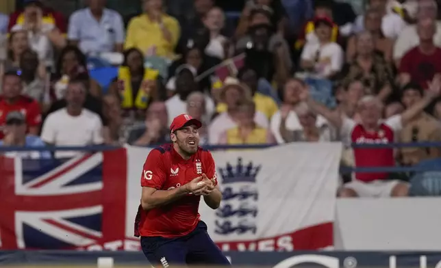 England's Jamie Overton takes the catch to dismiss West Indies' Gudakesh Motie during the second T20 cricket match at Kensington Oval in Bridgetown, Barbados, Sunday, Nov. 10, 2024. (AP Photo/Ricardo Mazalan)