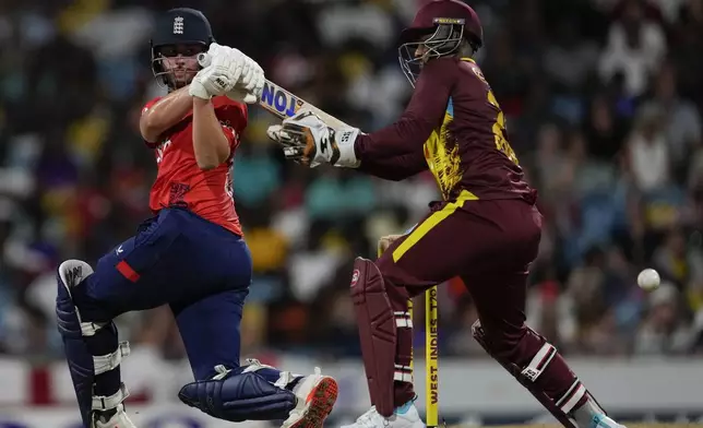 England's Will Jacks hits for six runs from a delivery of Roston Chase during the second T20 cricket match at Kensington Oval in Bridgetown, Barbados, Sunday, Nov. 10, 2024. (AP Photo/Ricardo Mazalan)