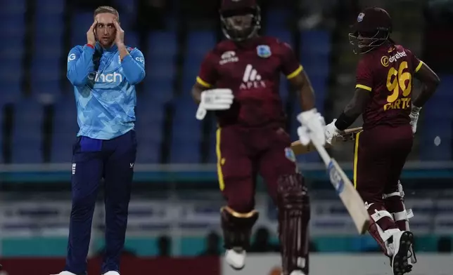 England's captain Liam Livingstone reacts after delivering as West Indies' Keacy Carty and Evin Lewis run during the first ODI cricket match at Sir Vivian Richards Ground in North Sound, Antigua and Barbuda, Thursday, Oct. 31, 2024. (AP Photo/Ricardo Mazalan)