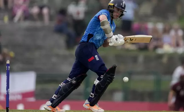 England's Sam Curran plays a shot during the first ODI cricket match against West Indies at Sir Vivian Richards Ground in North Sound, Antigua and Barbuda, Thursday, Oct. 31, 2024. (AP Photo/Ricardo Mazalan)