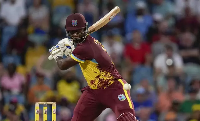 West Indies' Romario Shepherd plays a shot against England during the second T20 cricket match at Kensington Oval in Bridgetown, Barbados, Sunday, Nov. 10, 2024. (AP Photo/Ricardo Mazalan)