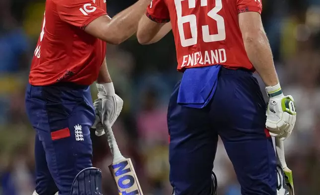 England's captain Jos Buttler and Will Jacks celebrate runs against West Indies during the second T20 cricket match at Kensington Oval in Bridgetown, Barbados, Sunday, Nov. 10, 2024. (AP Photo/Ricardo Mazalan)