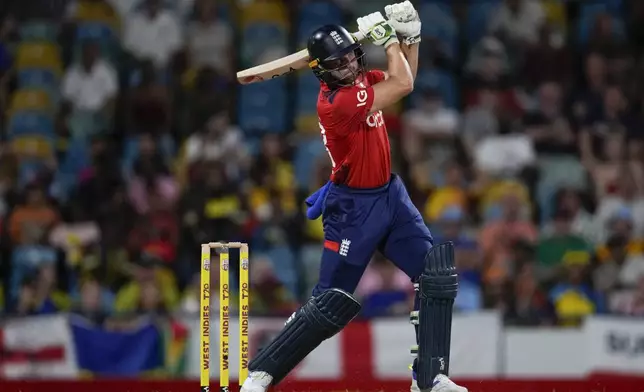 England's captain Jos Buttler plays a shot a shot for six runs against West Indies during the second T20 cricket match at Kensington Oval in Bridgetown, Barbados, Sunday, Nov. 10, 2024. (AP Photo/Ricardo Mazalan)