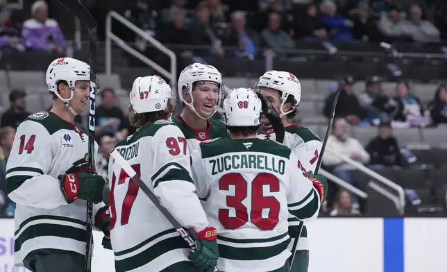 Minnesota Wild left wing Matt Boldy, center, celebrates with teammates after scoring a goal against the San Jose Sharks during the second period of an NHL hockey game Thursday, Nov. 7, 2024, in San Jose, Calif. (AP Photo/Godofredo A. Vásquez)