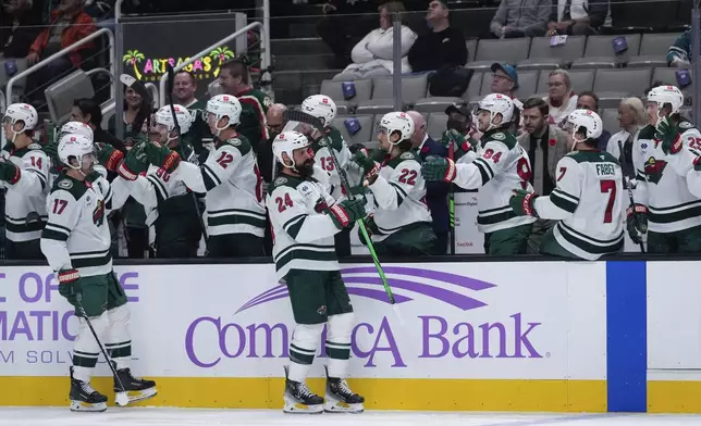 Minnesota Wild defenseman Zach Bogosian (24) celebrates with teammates after scoring a goal against the San Jose Sharks during the first period of an NHL hockey game Thursday, Nov. 7, 2024, in San Jose, Calif. (AP Photo/Godofredo A. Vásquez)