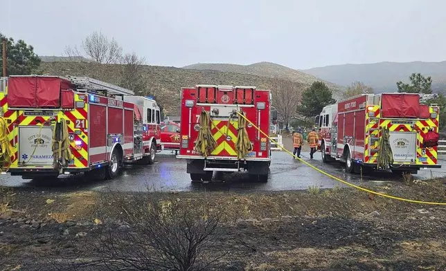 In this handout photo provided by the Reno Fire Department, fire crews battle the Callahan Fire, which caused the evacuations of hundreds of homes southwest of Reno, Nev., Monday, Nov. 11, 2024. (Reno Fire Department via AP)