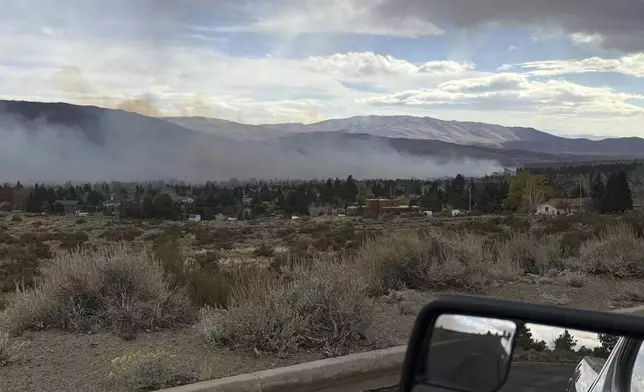 In this handout photo provided by the Reno Fire Department, fire crews battle the Callahan Fire, which caused the evacuations of hundreds of homes southwest of Reno, Nev., Monday, Nov. 11, 2024. (Reno Fire Department via AP)