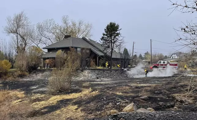 In this handout photo provided by the Reno Fire Department, fire crews battle the Callahan Fire, which caused the evacuations of hundreds of homes southwest of Reno, Nev., Monday, Nov. 11, 2024 . (Reno Fire Department via AP)