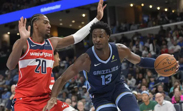 Memphis Grizzlies forward Jaren Jackson Jr. (13) handles the ball against Washington Wizards forward Alexandre Sarr (20) in the first half of an NBA basketball game Friday, Nov. 8, 2024, in Memphis, Tenn. (AP Photo/Brandon Dill)