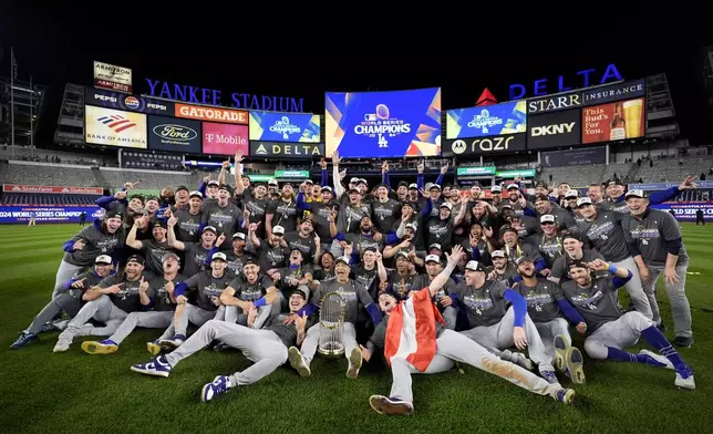 The Los Angeles Dodgers pose for a team picture after their win against the New York Yankees in Game 5 to win the baseball World Series, Thursday, Oct. 31, 2024, in New York. (AP Photo/Ashley Landis)