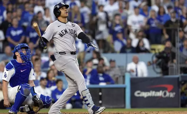 New York Yankees' Juan Soto, right, watches his home run along with Los Angeles Dodgers catcher Will Smith during the third inning in Game 2 of the baseball World Series, Saturday, Oct. 26, 2024, in Los Angeles. (AP Photo/Godofredo A. Vásquez)