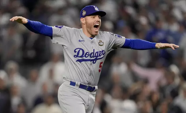 Los Angeles Dodgers first baseman Freddie Freeman celebrates their win against the New York Yankees in Game 5 to win the baseball World Series, Wednesday, Oct. 30, 2024, in New York. (AP Photo/Ashley Landis)