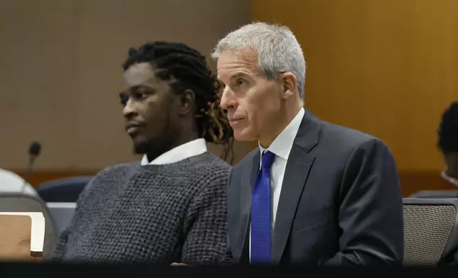 FILE - Young Thug, whose real name is Jeffery Lamar Williams, and his lawyer, Brian Steel, watch Judge Ural Glanville speak during the hearing of key witness Kenneth Copeland at the Fulton County Superior Court in Atlanta on June 10, 2024. (Miguel Martinez/Atlanta Journal-Constitution via AP, File, File)
