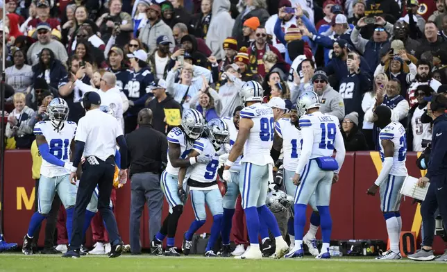 Dallas Cowboys wide receiver KaVontae Turpin (9) celebrates with teammates after scoring a 99-yard touchdown off a kickoff return during the second half of an NFL football game against the Washington Commanders, Sunday, Nov. 24, 2024, in Landover, Md. (AP Photo/Nick Wass)