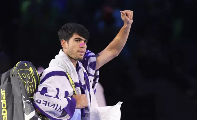 Spain's Carlos Alcaraz leaves the pitch at the end of the singles tennis match of the ATP World Tour Finals against Germany's Alexander Zverev, at the Inalpi Arena, in Turin, Italy, Friday, Nov. 15, 2024. (AP Photo/Antonio Calanni)