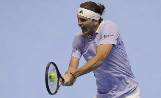 Germany's Alexander Zverev returns the ball to Spain's Carlos Alcaraz during their singles tennis match of the ATP World Tour Finals at the Inalpi Arena, in Turin, Italy, Friday, Nov. 15, 2024. (AP Photo/Antonio Calanni)