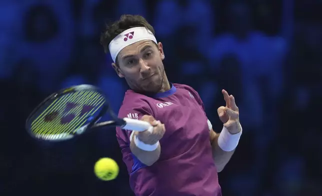 Norway's Casper Ruud returns the ball to Russia's Andrey Rublev during their singles tennis match of the ATP World Tour Finals at the Inalpi Arena, in Turin, Italy, Friday, Nov. 15, 2024. (AP Photo/Antonio Calanni)