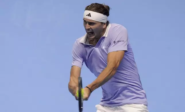 Germany's Alexander Zverev returns the ball to Spain's Carlos Alcaraz during their singles tennis match of the ATP World Tour Finals at the Inalpi Arena, in Turin, Italy, Friday, Nov. 15, 2024. (AP Photo/Antonio Calanni)