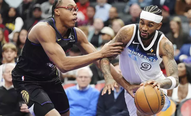 Minnesota Timberwolves' Nickeil Alexander-Walker (9) drives past Toronto Raptors' Scottie Barnes (4) during first half NBA basketball action in Toronto on Thursday, Nov. 21, 2024. (Frank Gunn/The Canadian Press via AP)