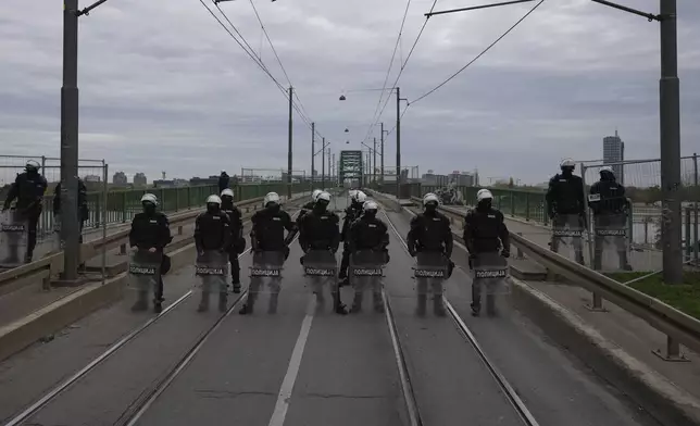 Serbian police officers guard Old Sava Bridge, which is closed for removal, in Belgrade, Serbia, Wednesday, Nov. 20, 2024. (AP Photo/Darko Vojinovic)