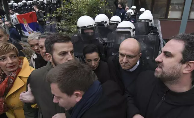 Serbian police stand guard as opposition protesters demand arrests over a deadly roof collapse at a railway station in Novi Sad, Serbia, Wednesday, Nov. 20, 2024. (AP Photo)