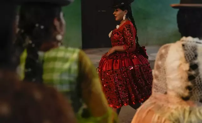 Women model creations by a local designer at a Chola fashion show, promoting the Andean style and beauty of Aymara women, in Viacha, Bolivia, Friday, Nov. 29, 2024. (AP Photo/Juan Karita)