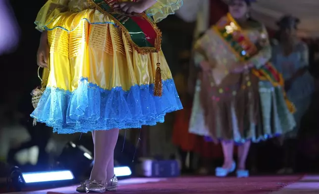 Women model creations by a local designer at a Chola fashion show, promoting the Andean style and beauty of Aymara women, in Viacha, Bolivia, Friday, Nov. 29, 2024. (AP Photo/Juan Karita)