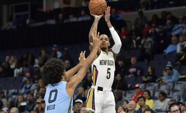 New Orleans Pelicans guard Dejounte Murray (5) shoots against Memphis Grizzlies forward Jaylen Wells (0) in the first half of an Emirates NBA Cup basketball game Friday, Nov. 29, 2024, in Memphis, Tenn. (AP Photo/Brandon Dill)